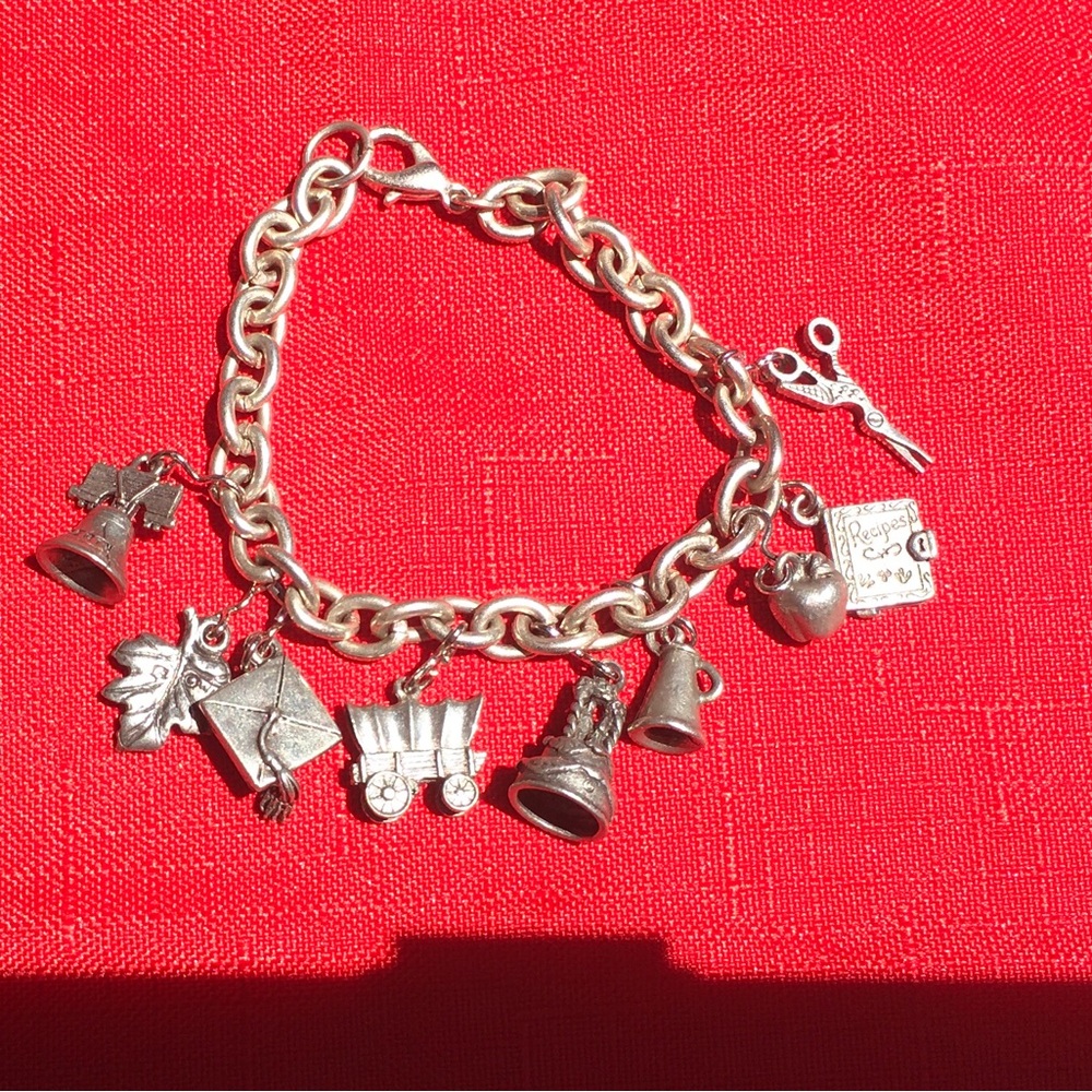 Vintage Charm Bracelet.  7.5”.  Sturdy interlocking chain links. 9 charms.